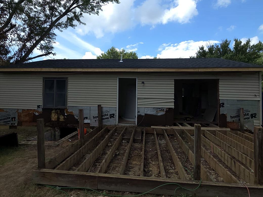 Deck frame being built on the back of a house