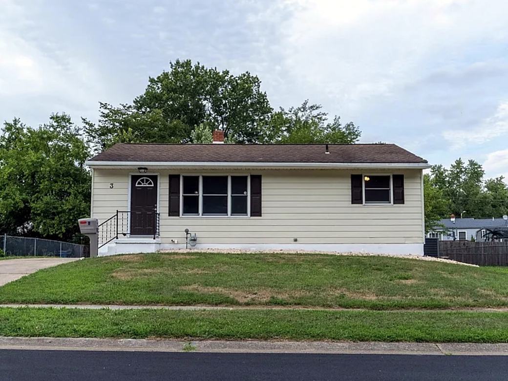 Ranch home with a new front door, shutters and railing
