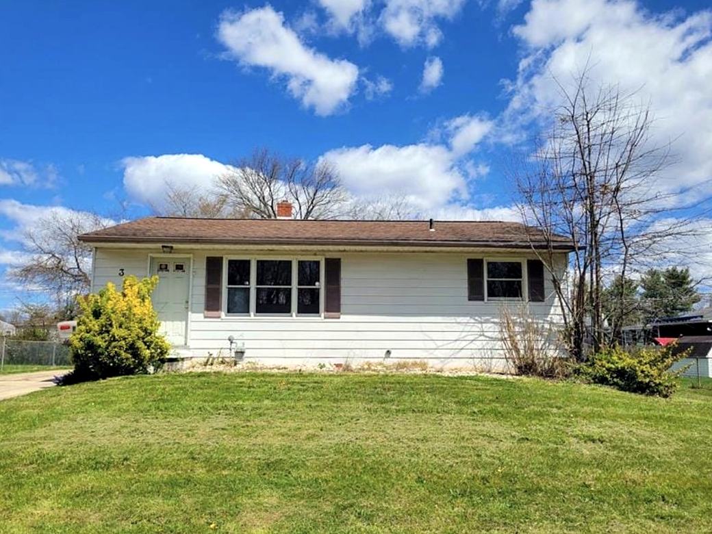 Ranch home with an old front door and red shutters